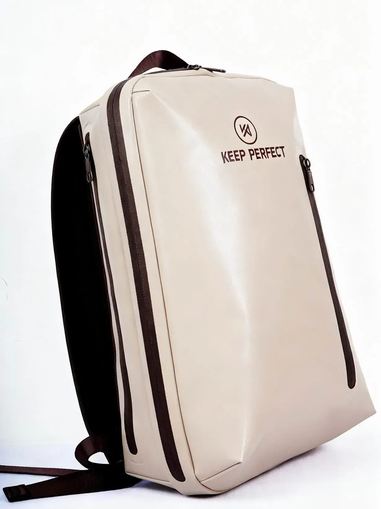 Four waterproof backpacks in roll-top, zip and flap styles laid out on wet granite after rainfall