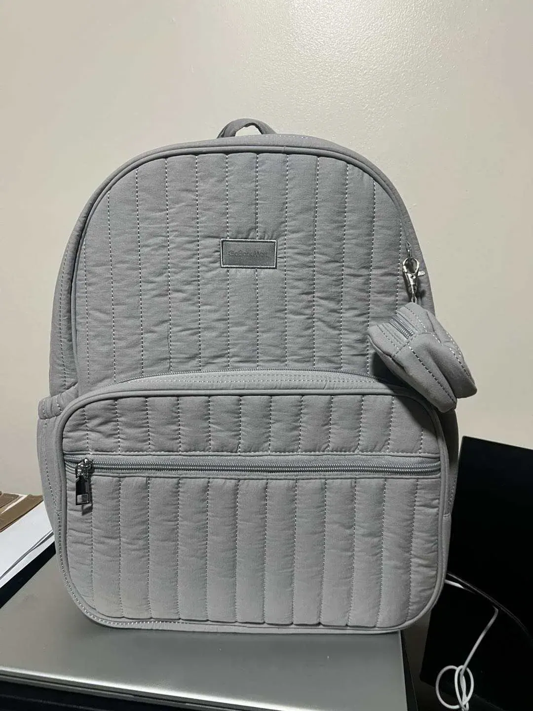 Ten budget waterproof backpacks under 50 USD lined up by price band with welded and coated bodies side by side