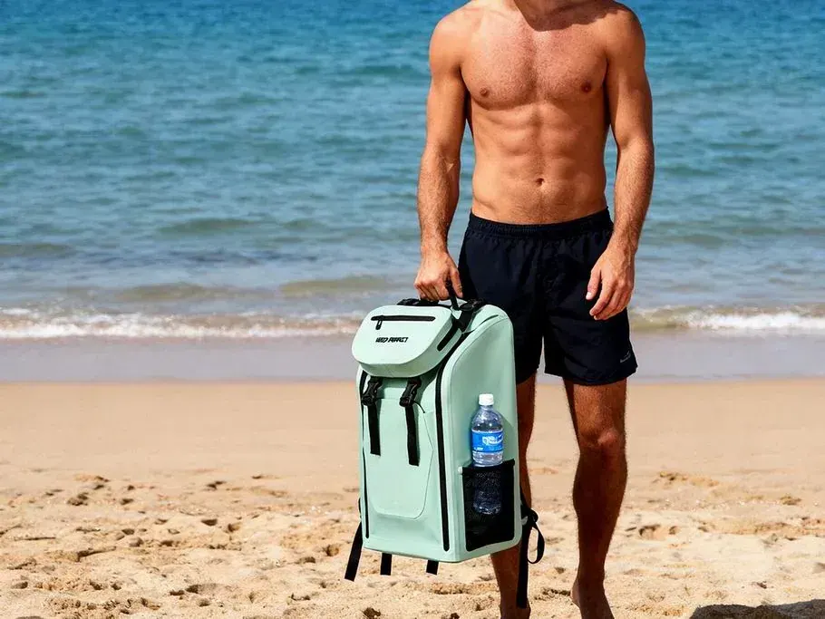 Roll-top dry backpack with an isolated external wet compartment holding damp swimwear separate from sealed dry clothing