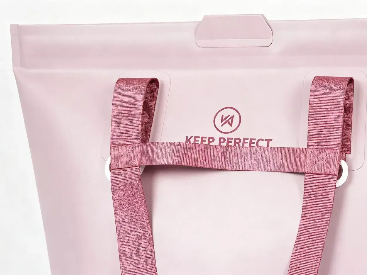 Perforated EVA tote tilted to pour out water with the wall and base holes visible while draining on a wet surface