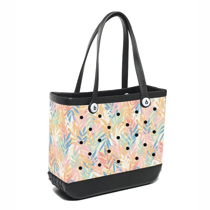 Underside view of a large perforated EVA tote showing continuous base rails and the fillet where handle meets rim