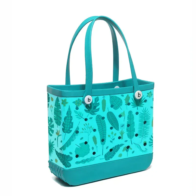 Perforated EVA tote being rinsed with a hose after a beach day with sand and water washing through the open holes