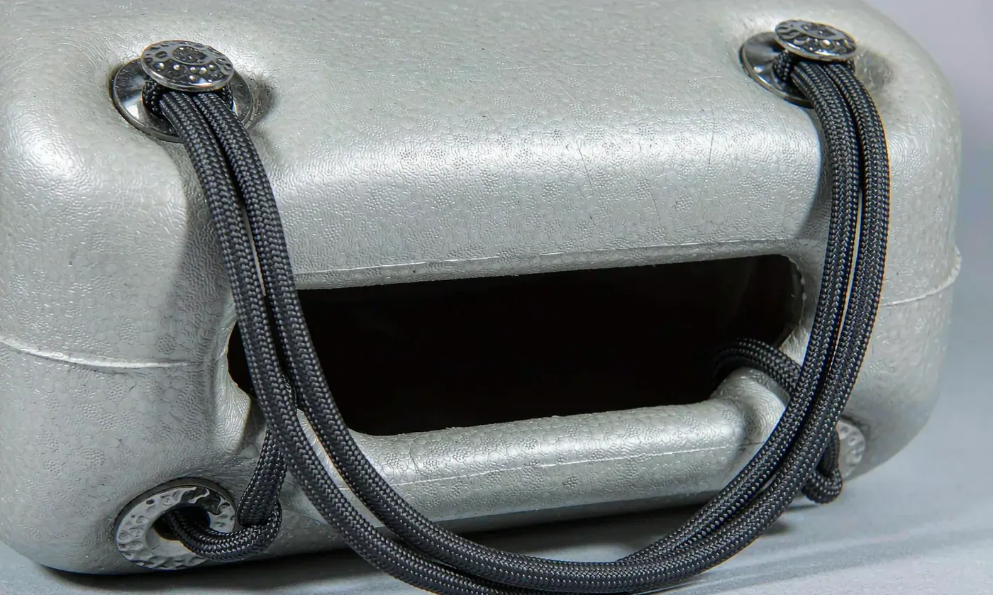 Close view of a molded EVA tote handle showing its cross-section and the fillet radius where it meets the rim