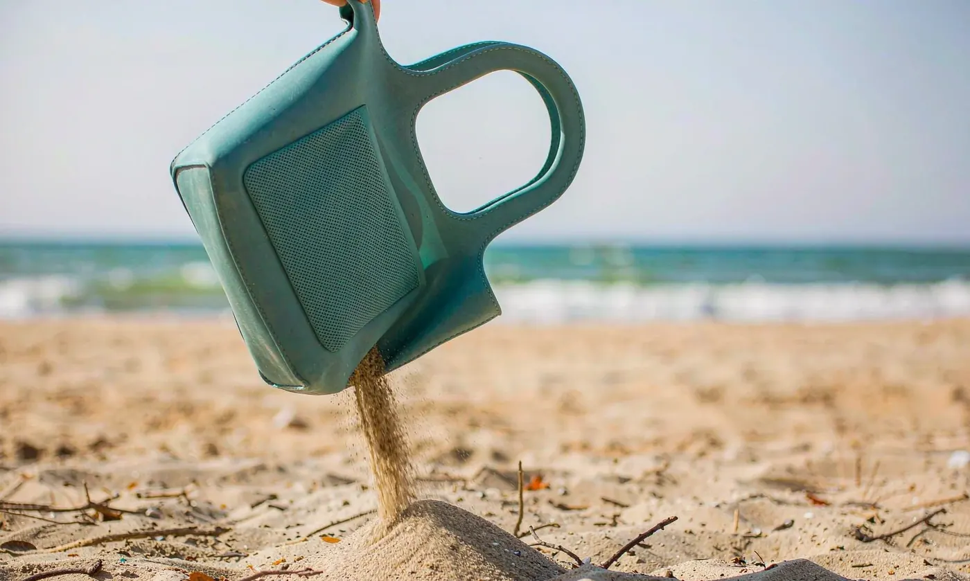 Perforated EVA tote turned upside down and shaken so sand falls away through the perforations after a beach session