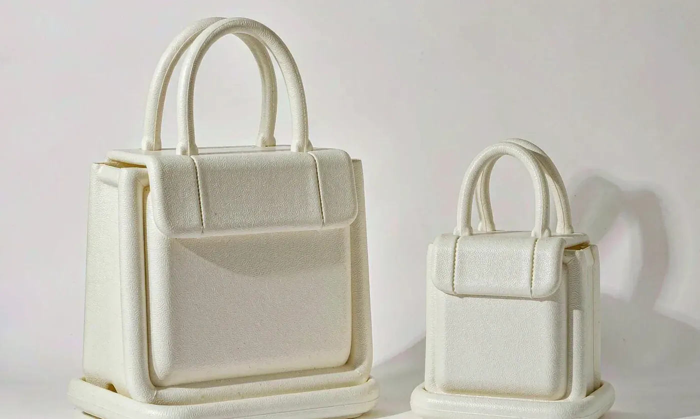 Large and small perforated EVA totes placed side by side showing the difference in mouth width, height and base footprint