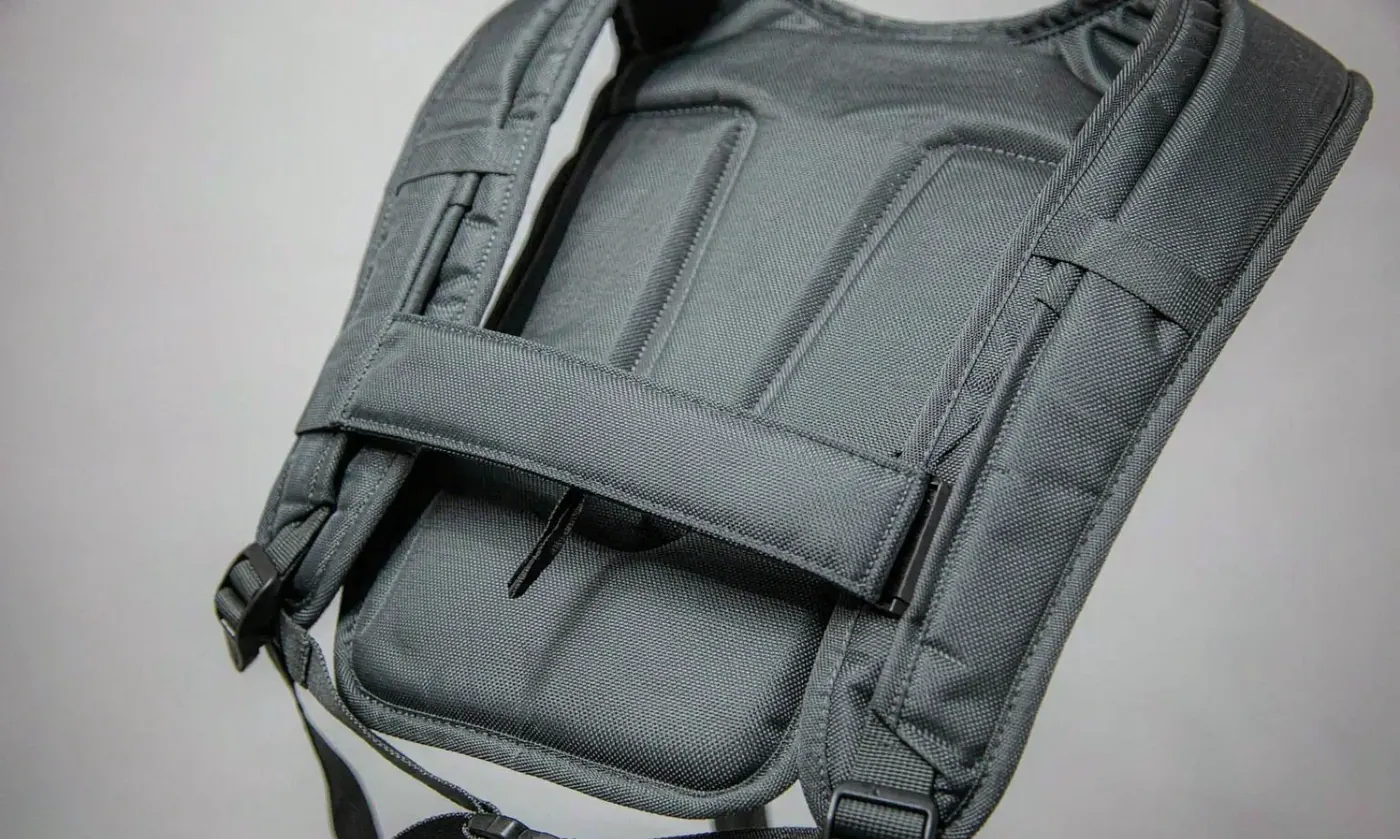 Detailed view of a shoulder strap anchor on a fishing bag showing the stainless fitting and the reinforced stitching