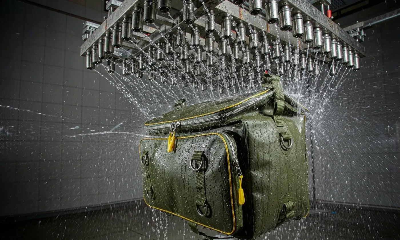 Fly fishing pack under a directed spray test with boxes and tools loaded to check splash protection