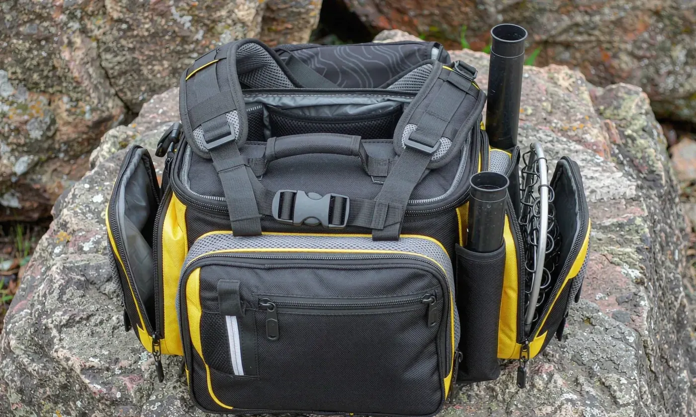 Angler wearing a hands-free fishing chest pack made from lightweight coated nylon with a tray drop-down open in front