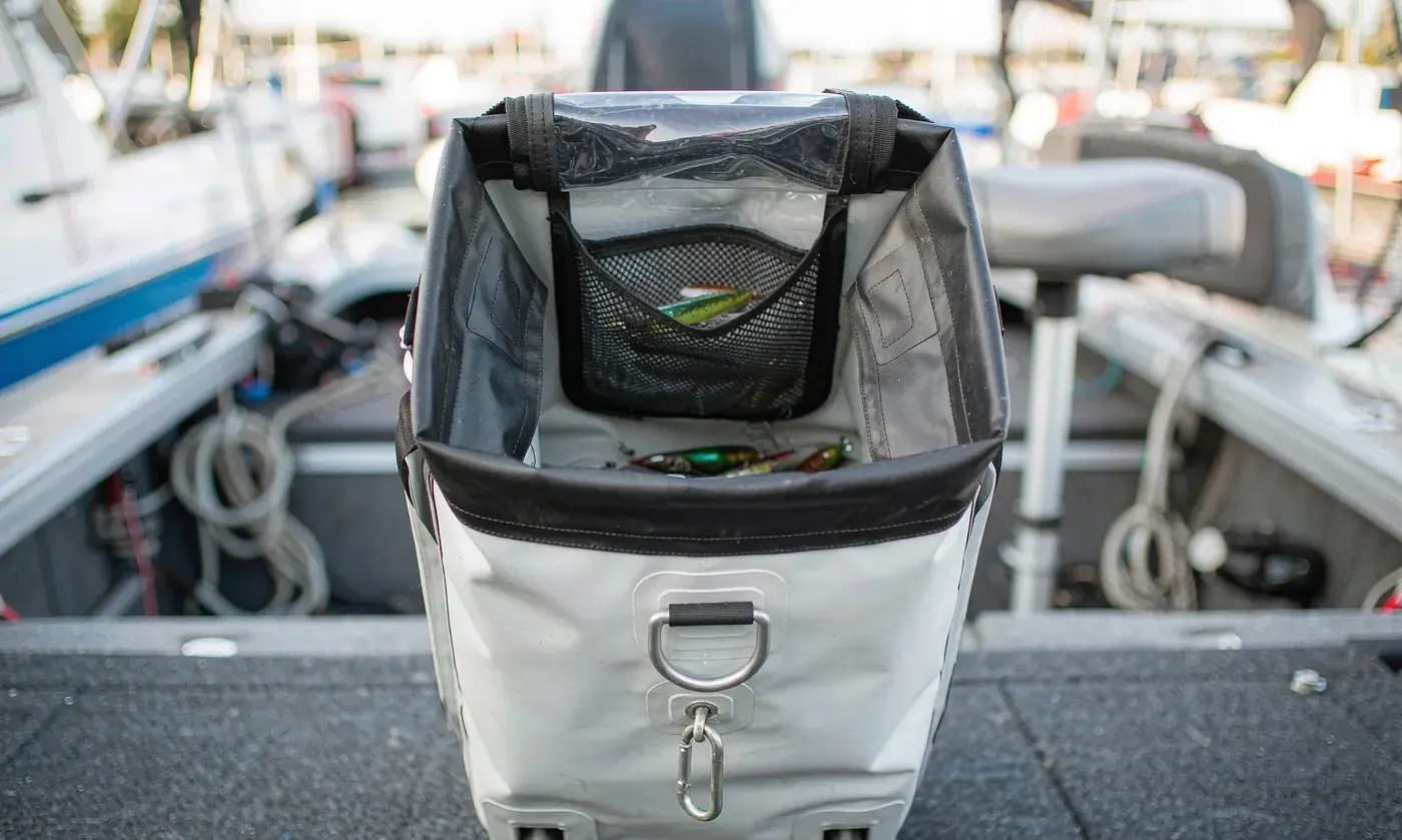 Open top fishing tackle tote made from heavy PVC tarpaulin standing on a boat deck with trays visible inside